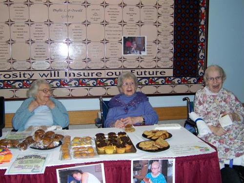 Gallery Image Getting into the spirit of a worthy cause Madeline Fleischman (right) calls out for customers as Rhea Silver and Goldie Kaplan prepare for bake sale business.JPG
